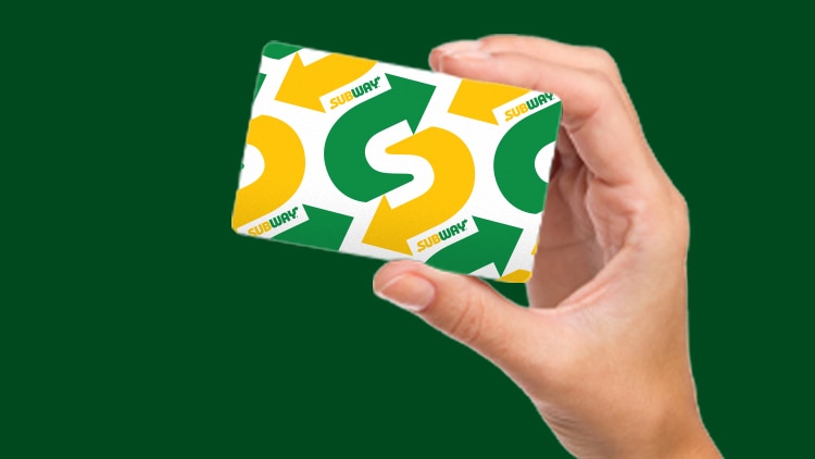 Hand holding Subway gift card 